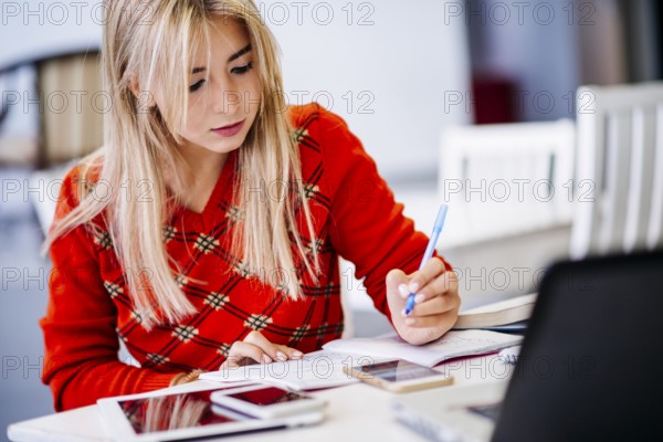 Young female writing notebook