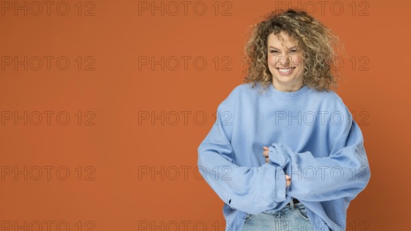 Beautiful woman with curly blonde hair smiling