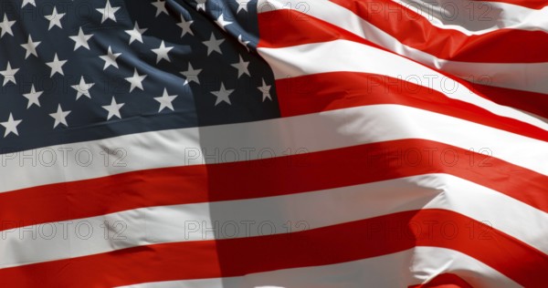 American Flag Waving in the Wind against blue sky
