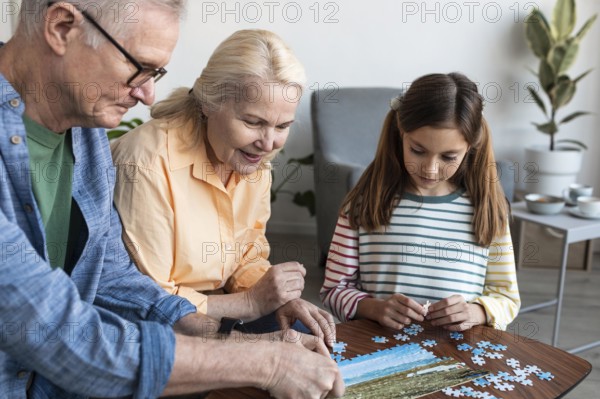 Grandparents girl doing puzzle close up