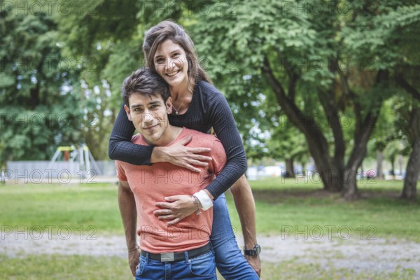 Boyfriend carrying his girlfriend on piggyback