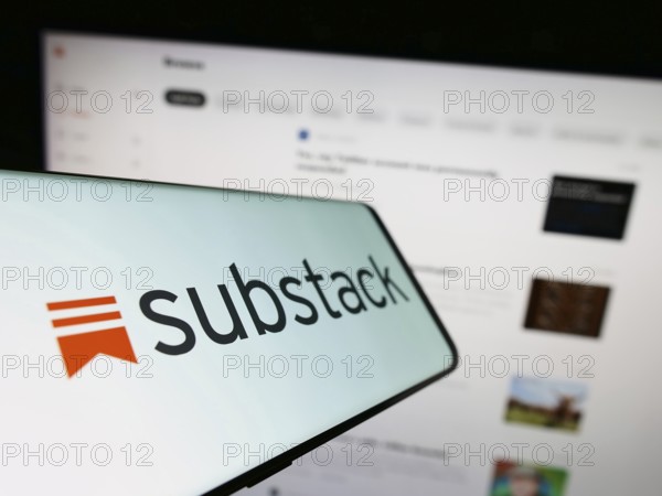 Stuttgart, Germany, 12-19-2022: Smartphone with logo of American subscription company Substack Inc. on screen in front of website. Focus on center-left of phone display, Europe
