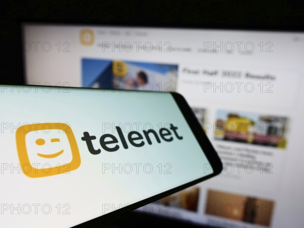 Stuttgart, Germany, 07-30-2022: Mobile phone with logo of Belgian company Telenet Group Holding N.V. on screen in front of business website. Focus on left of phone display, Europe