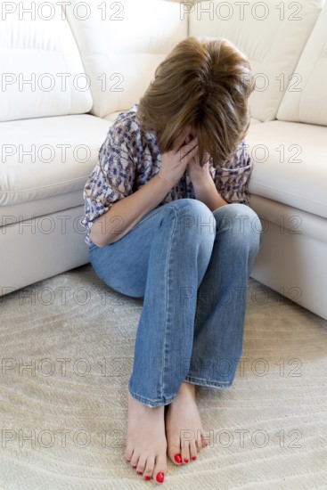 Woman crying covering her face with a hands