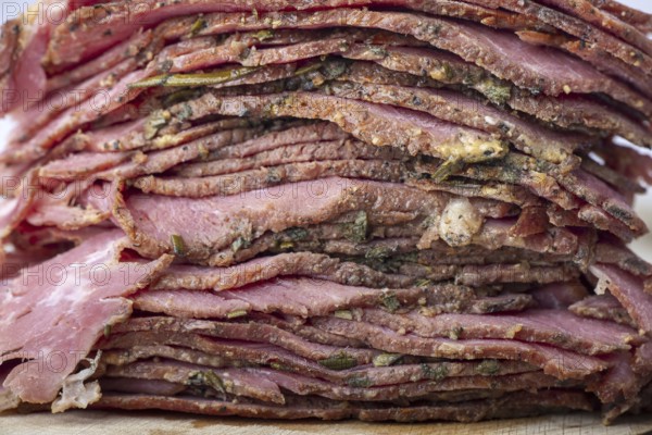 Stack of sliced pastrami meat