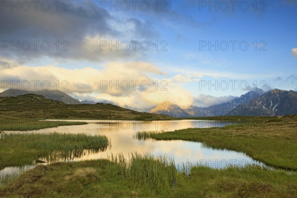 Cloudy sky at Jaufenpass, Passo di Monte Giovo, mountain lake, evening mood, Sterzing, South Tyrol, Italy, Europe