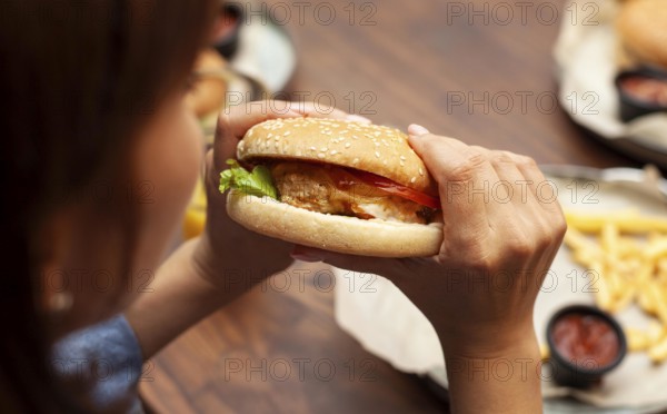 High angle woman eating burger