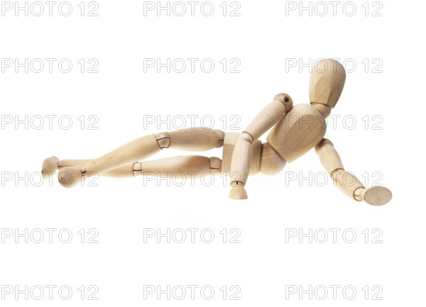 Wood mannekin laying onn side over white