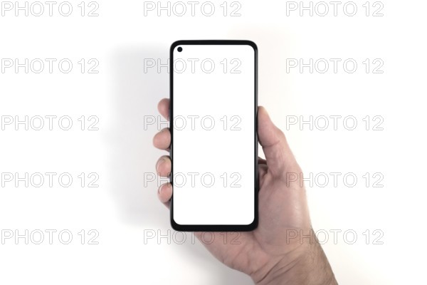 hand holding smartphone with blank white screen against white background, person using smartphone template with copy space