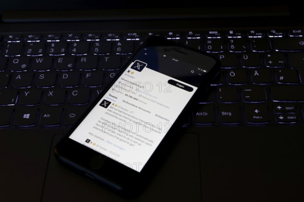 Symbolic image social media, close-up of a smartphone on an illuminated computer keyboard with X logo in the Twitter app, Germany, Europe