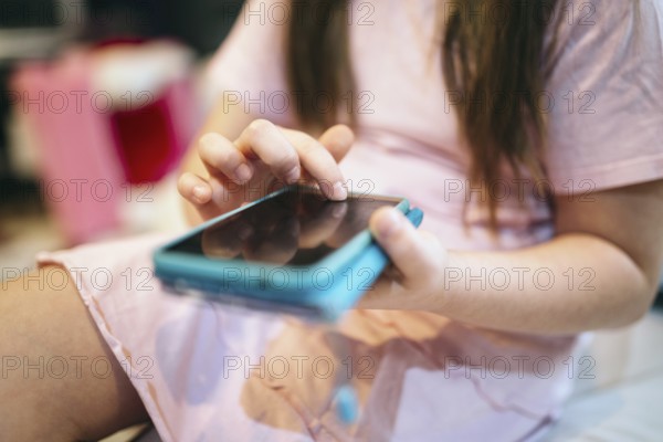 Crop girl using smartphone