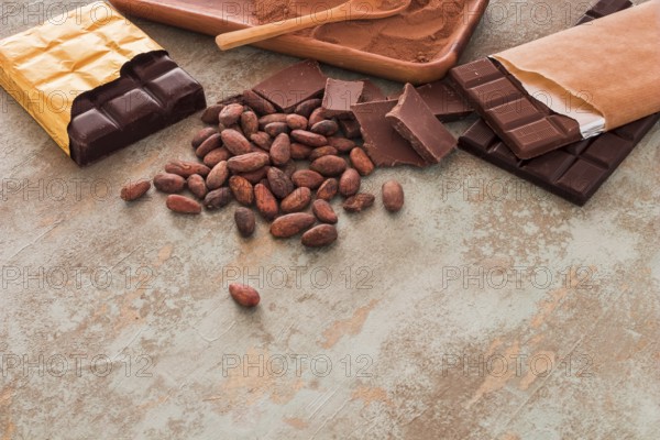Chocolate bars cocoa beans powder grunge background