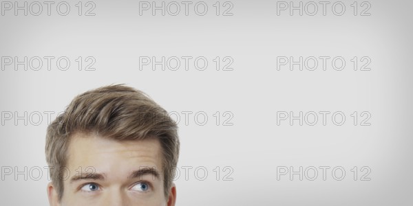 male eyes looking up towards copy space