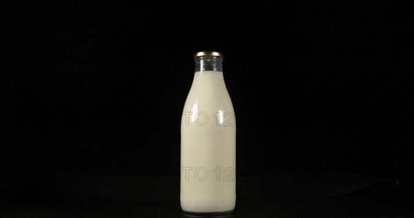 Bottle of Milk against Black Background