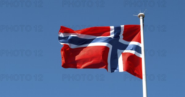 Norvegian Flag Waving in the Wind against blue sky