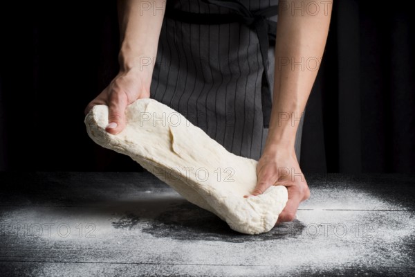 Woman kneading dough table