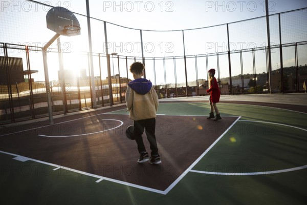 Children playing basketball field. High resolution photo