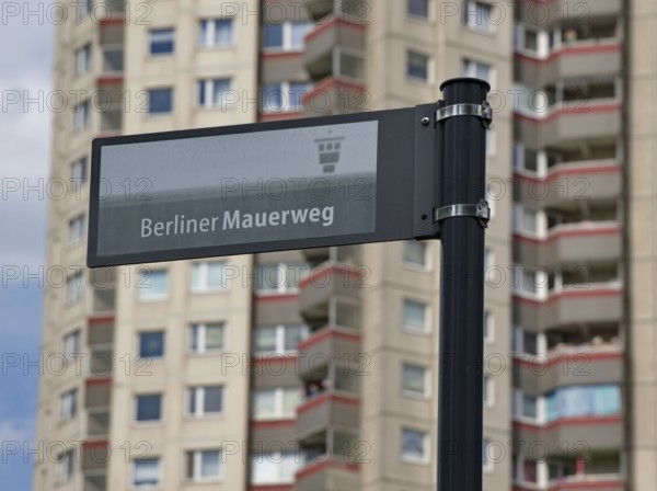 Sign with the inscription Berliner Mauerweg in front of a high-rise building in Gropiusstadt, Neukölln district, Berlin, Germany, Europe