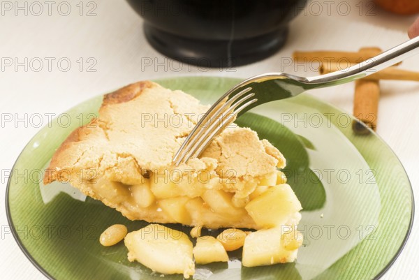 Fresh homemade apple pie over green glass dish macro colseup eating with fork