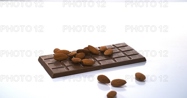 Almonds falling on Milk Chocolate tablet