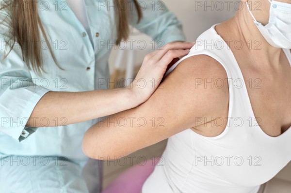 Physiotherapist undergoing therapy with female patient