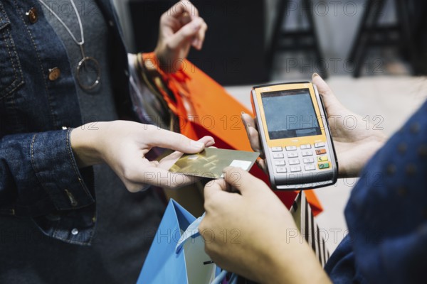 Anonymous woman paying shop. High resolution photo