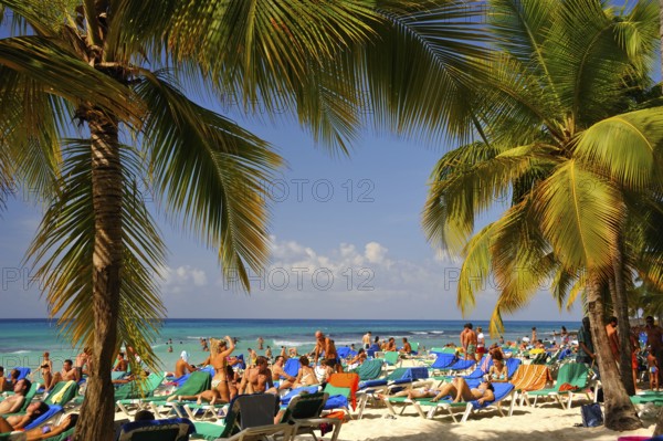 Holidaymakers on a tropical beach, Bayahibe, Dominican Republic, Central America
