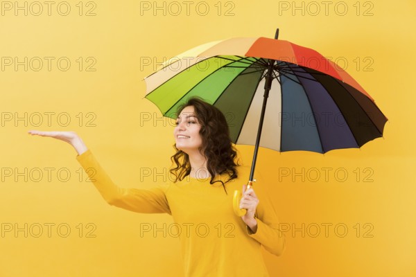 Front view woman with rainbow umbrella
