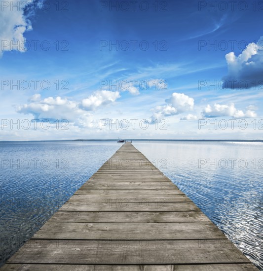 Old wooden pier on big blue lake
