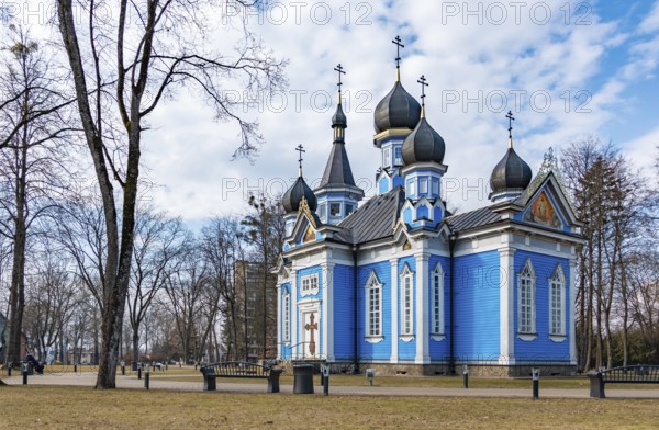A picture of the blue Joy of All Who Sorrow Church and the nearby park (Druskininkai)