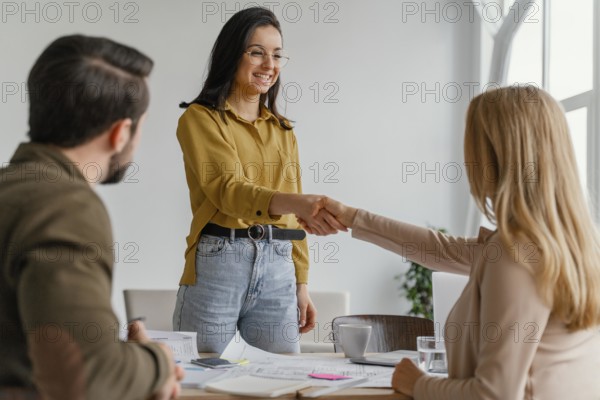 Businesswomen shaking hands work