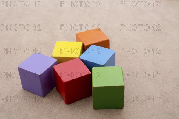Colorful building blocks on a brown background