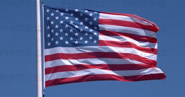 American Flag Waving in the Wind against blue sky