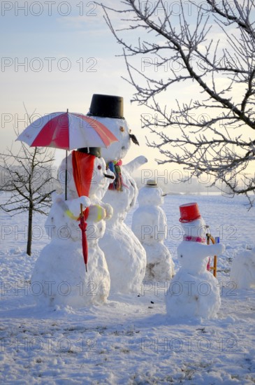 Snowman Family with animal figures, winter landscape Snowman Family with animal figures, winter landscape