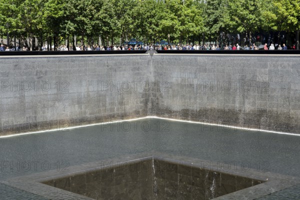 New York, United States of America, September 19, 2019: People standing at the north pool of the World Trade Center Ground Zero Memorial in Lower Manhattan