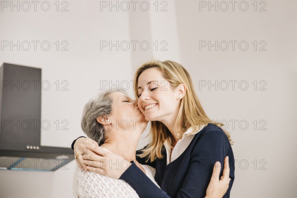 Daughter kissing mom mothers day