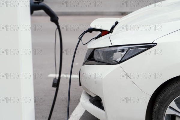 Side view automobile being charged electric vehicle charging station. Beautiful photo