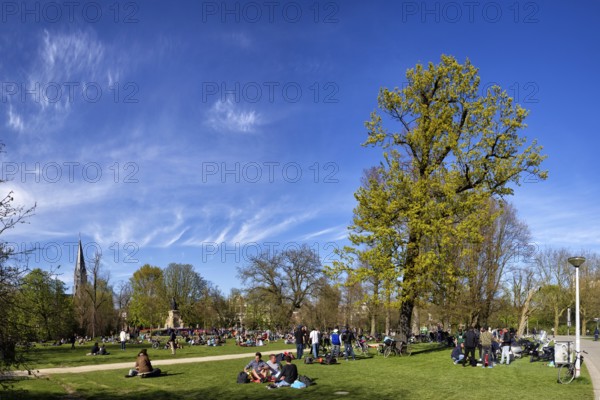 People relaxing at a picnic in Vondelpark in Amsterdam, Netherlands in spring. People relaxing at a picnic in the Vondelpark in Amsterdam, Netherlands in the spring