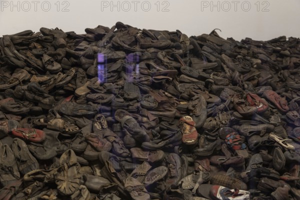 A picture of an exhibit inside the Memorial and Museum Auschwitz I that shows a collection of shoes from the prisoners