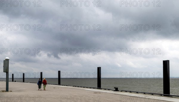 Women walking on the flood pier on the lock island, Wilhelmshaven, Lower Saxony, Germany, Europe