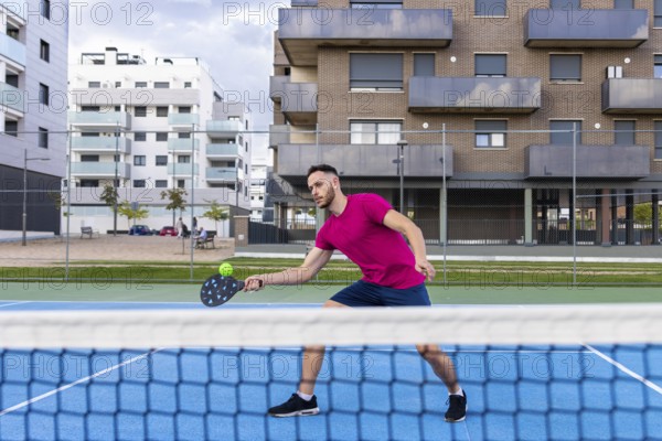 Young Man Pickleball Player Playing Pickleball in Court