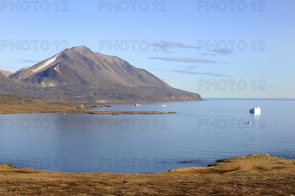Iceberg and mountain, Dundas Harbour, Devon Island, Nunavut, Canada, North America