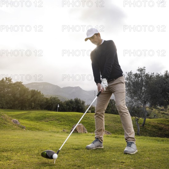 Man playing golf field with club
