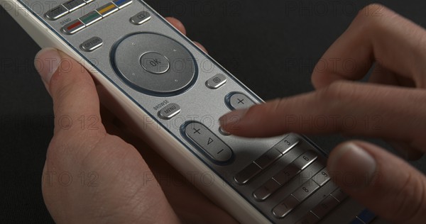 Hands of Woman with remote control