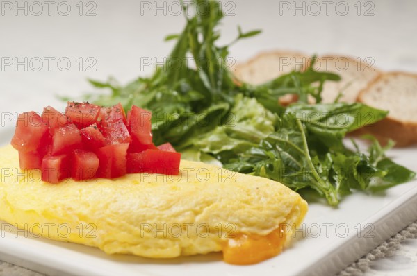 Home made omelette with cheese tomato and rucola rocket salad arugola