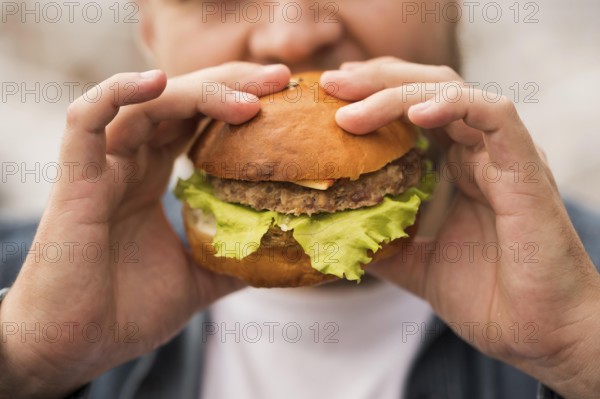 close up man eating burger. High resolution photo