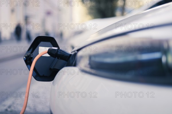 Electric car recharging with charge cable and plug leading to charge point
