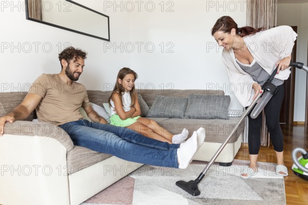 Woman vacuuming carpet