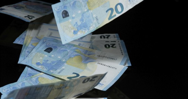 Euros Money Falling against Black Background