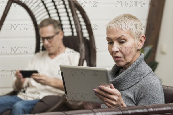 Senior couple looking through their devices